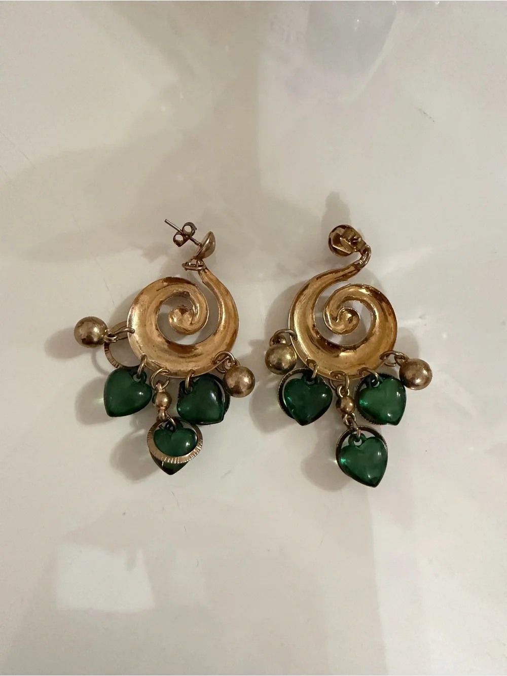 Gold Swirl Drop Earrings with Green Heart Charms